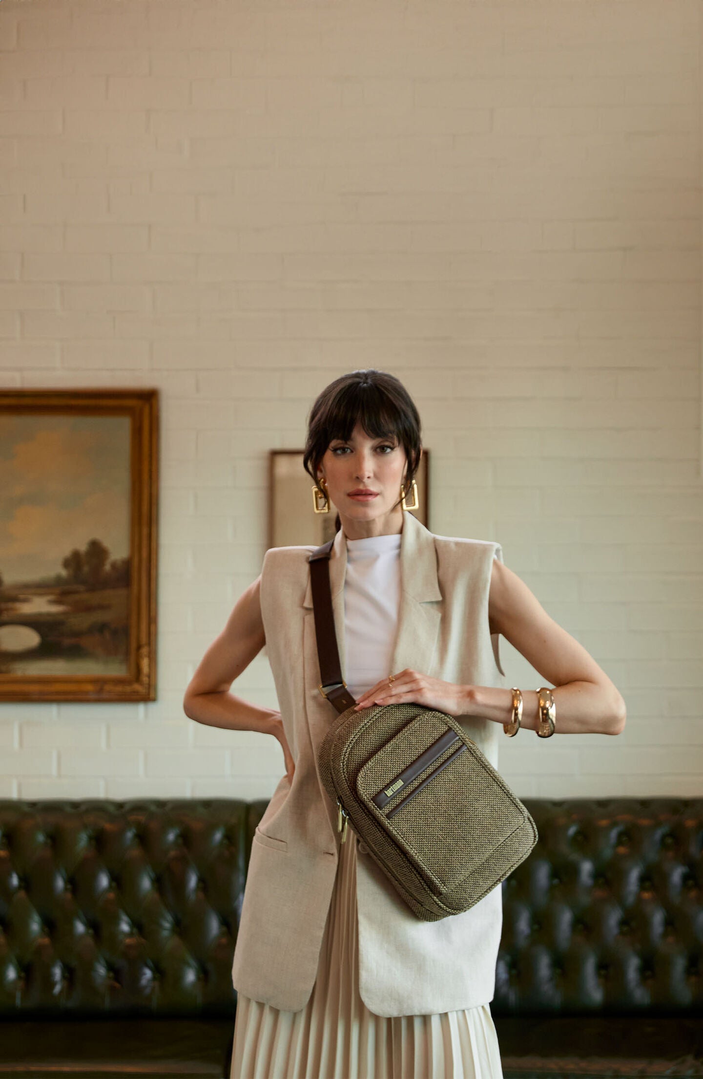 Female model wearing the Tweed Sling Bag in the front. Click here to shop now.