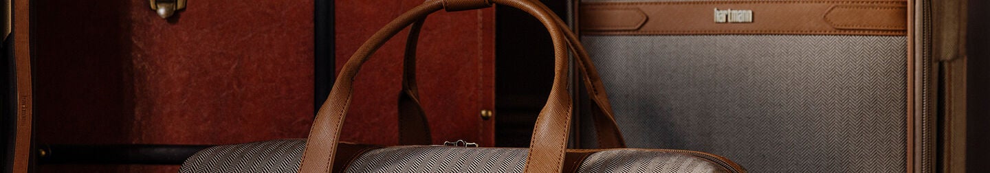 Top product listing page banner shows the Herringbone Deluxe Carry-On spinner and Weekend Duffel bag in Terracotta. Scroll down below to explore the full collection.