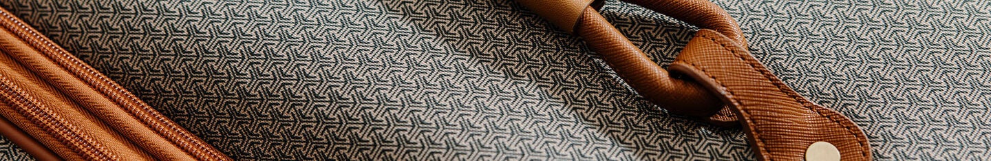 Up close shot of the Luxe II fabric material. Scroll down below to shop all our softside luggage styles.